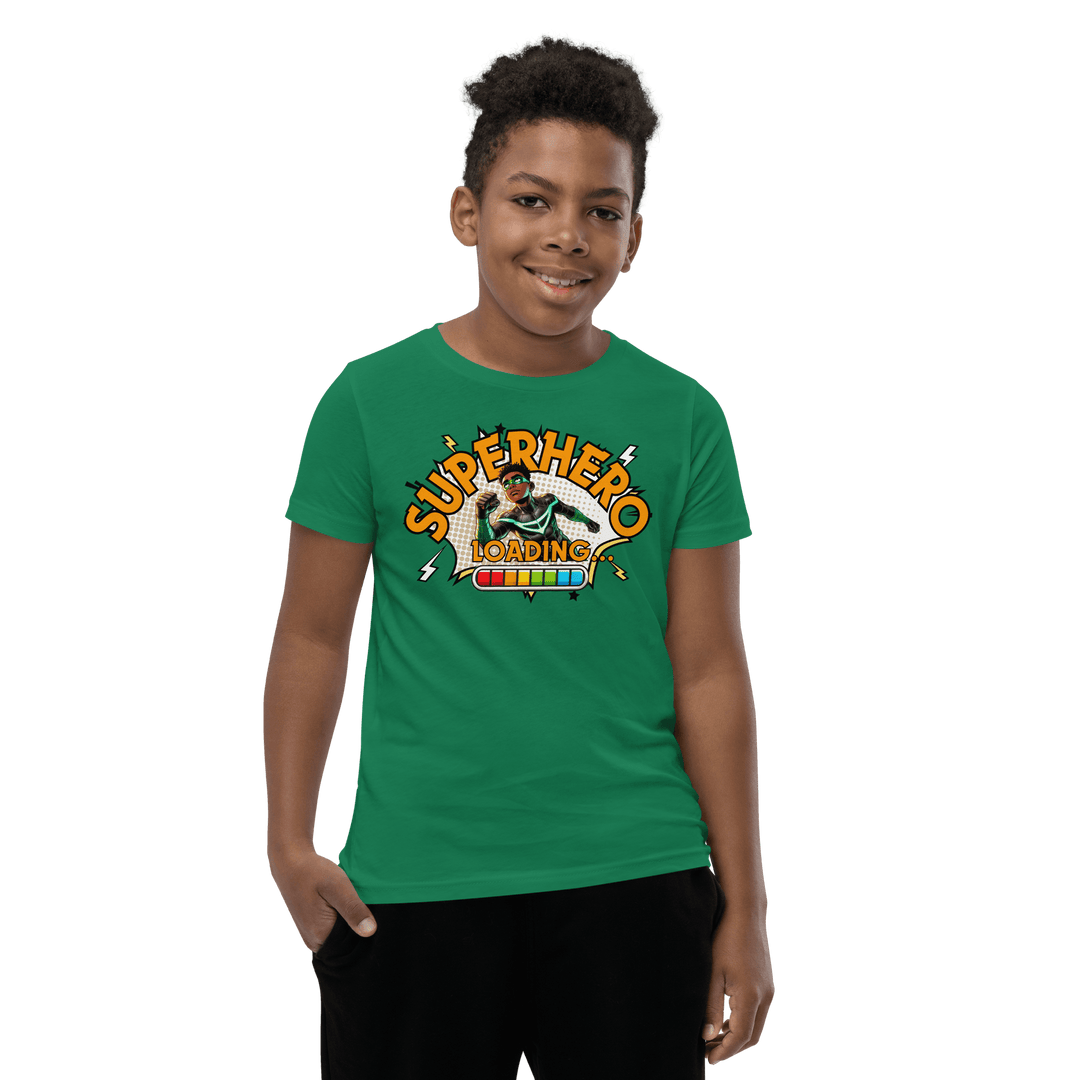Young Black boy smiling while wearing Green Superhero Loading T-shirt from TL Johnson’s Dream Big collection; motivational apparel celebrating growth and imagination