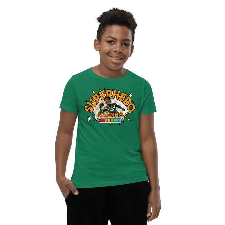 Young Black boy smiling while wearing Green Superhero Loading T-shirt from TL Johnson’s Dream Big collection; motivational apparel celebrating growth and imagination
