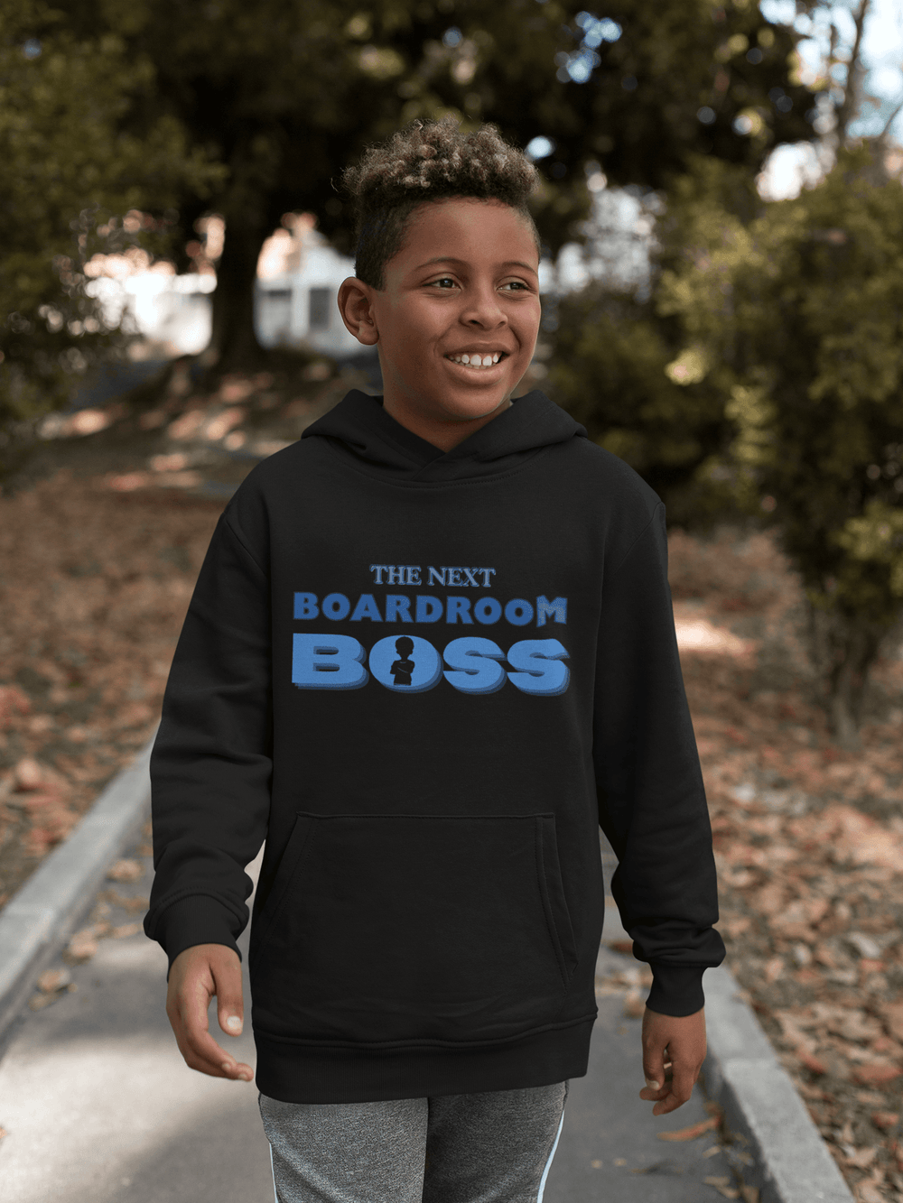 Young Black boy wearing The Next Boardroom Boss Hoodie from TL Johnson’s Mini Monarchs Apparel; With Blue Lettering. it's motivational fashion for future leaders.