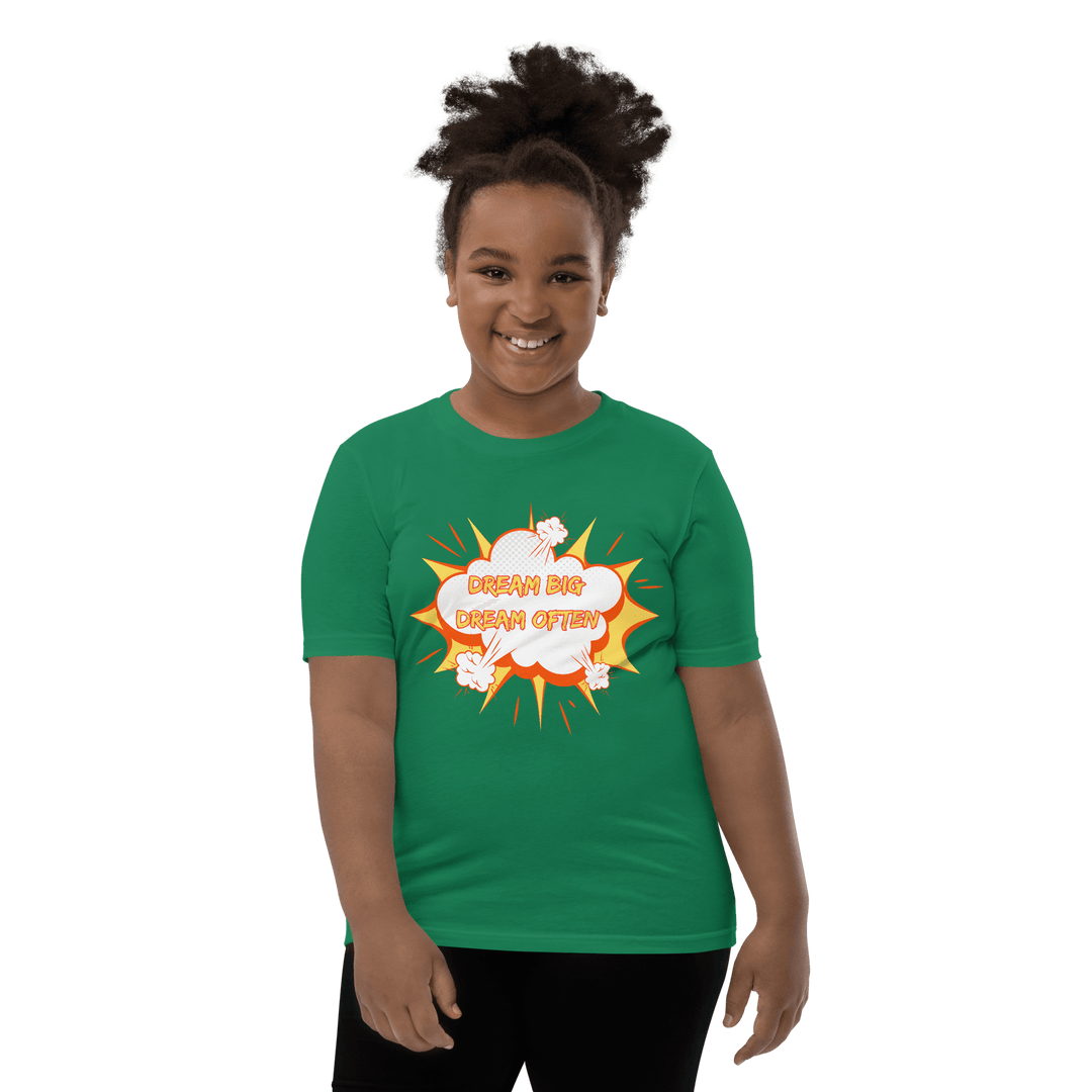Young Black girl wearing Green Dream Big T-shirt inspired by TL Johnson’s Dream Big Coloring Book: Careers in Black Excellence; empowerment apparel celebrating career goals.