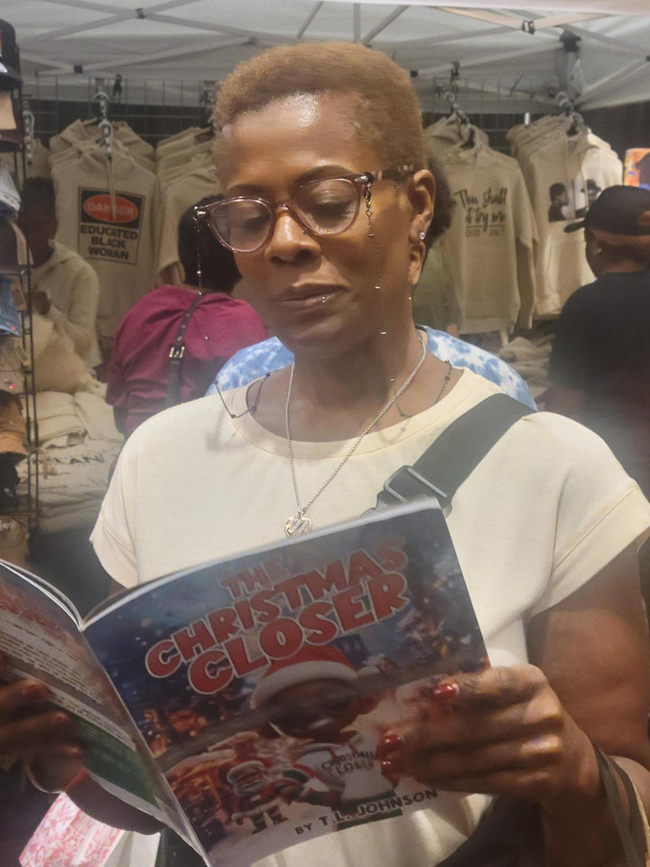 Person reading a book titled 'The Christmas Closer' in a store setting.