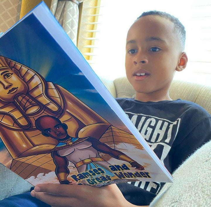 Young kid reading Ramses & The Great Wonder. Marveling at the story