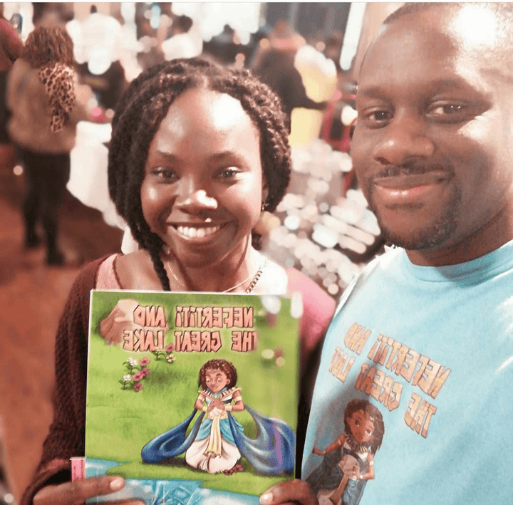 Smiling woman holding Nefertiti & The Great Lake standing next to author (Mini Monarchs 1.)